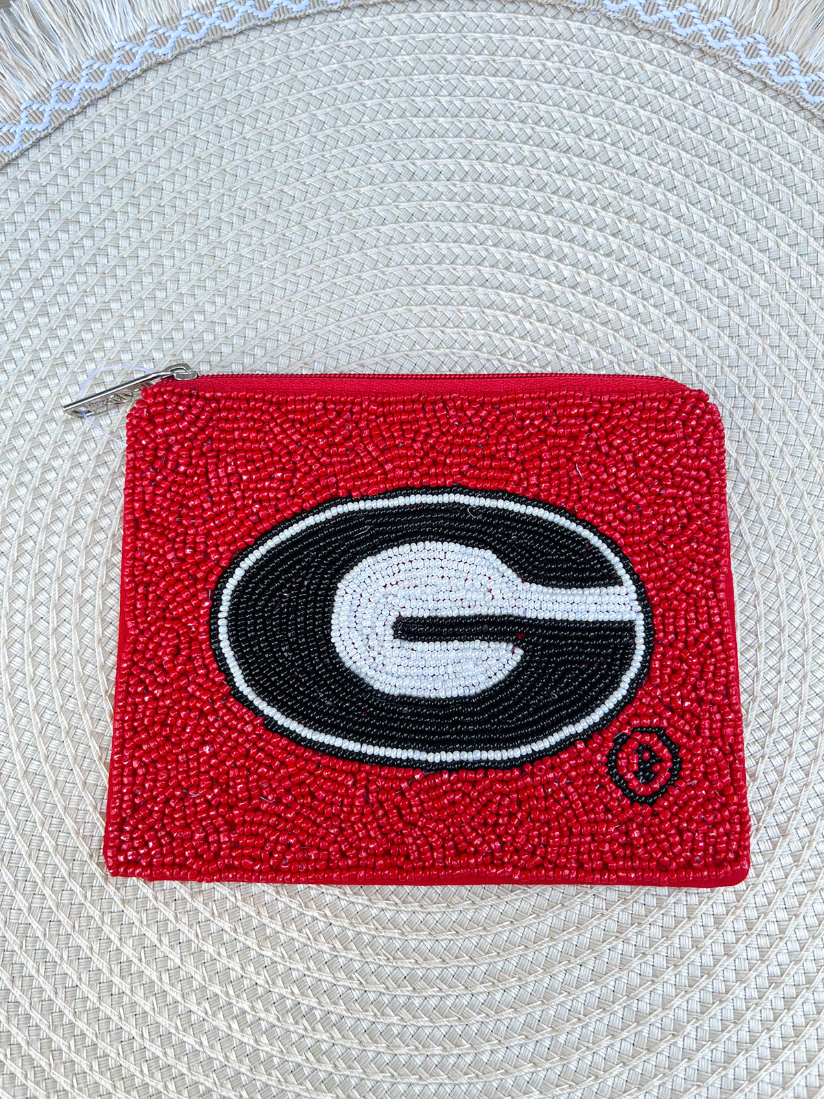 Hand-beaded Georgia Bulldogs pouch with bold team-inspired design, zip closure, and compact 5.5 x 4.5 inch size.