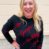 Black merino wool blend Georgia Bulldogs script sweater featuring red chain stitch embroidered hand-drawn collegiate artwork.