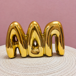 Gold Alpha Delta Pi bubble letter shelf décor with a polished metallic finish.
