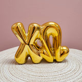 Gold Chi Omega bubble letter shelf décor with a polished metallic finish.