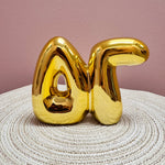Gold Delta Gamma bubble letter shelf décor with a polished metallic finish.
