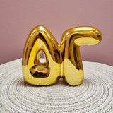 Gold Delta Gamma bubble letter shelf décor with a polished metallic finish.