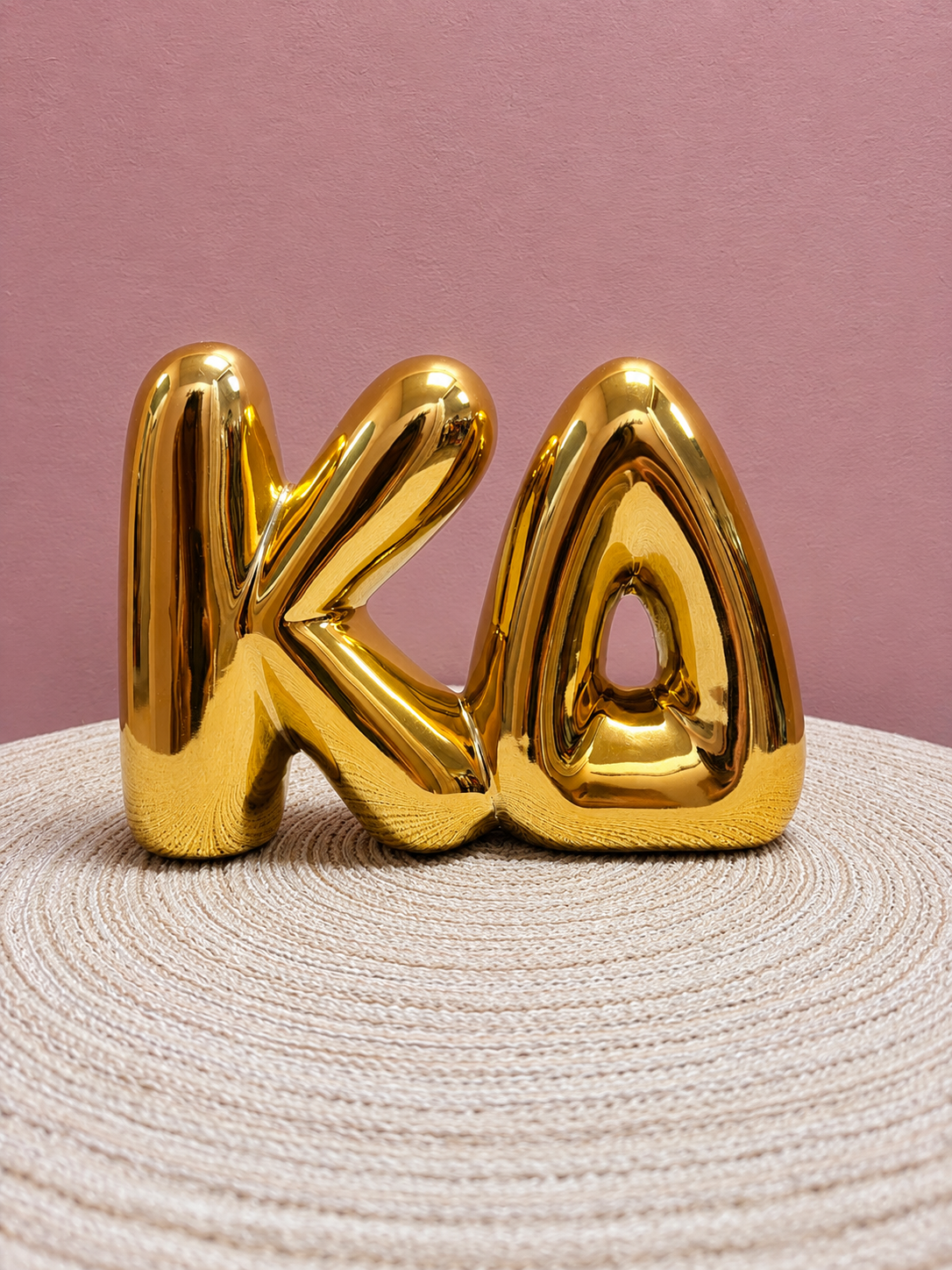 Gold Kappa Delta bubble letter shelf décor with a polished metallic finish.