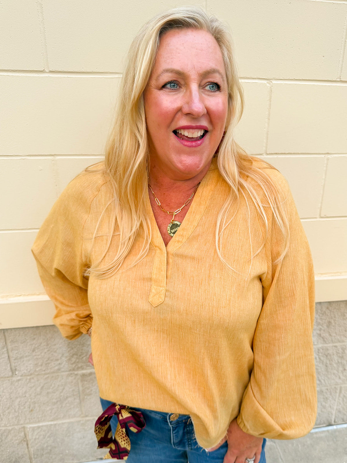 Mustard chartreuse gauze blouse with gathered neckline, bubble sleeves, V-neck placket, and lightweight woven texture.