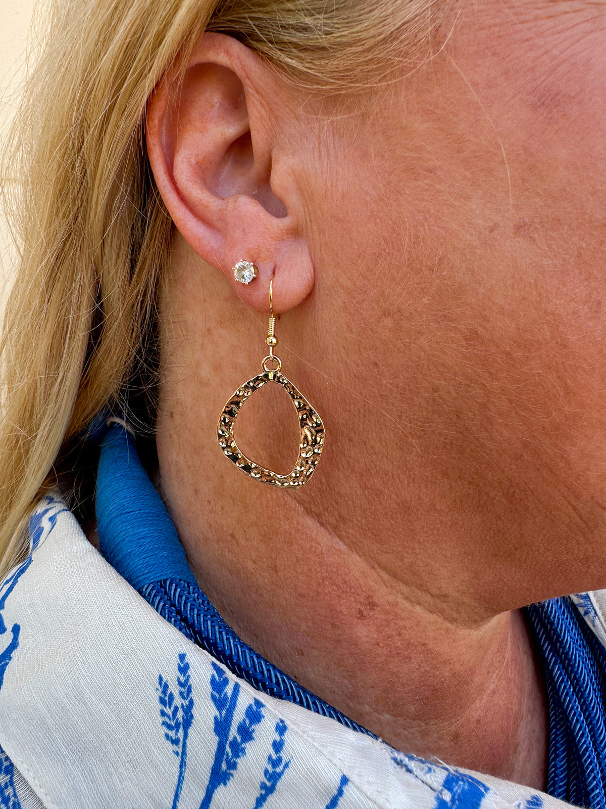 Hammered Metal Statement Earrings with a 2-inch drop in gold, featuring an organic shape and textured finish