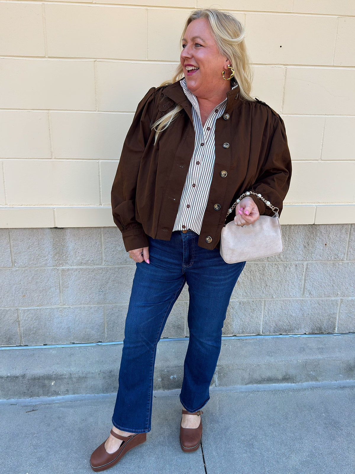 Hazelnut brown jacket with five front buttons, shoulder button accents, and a versatile high neckline
