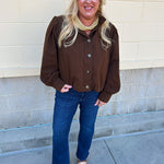 Hazelnut brown jacket with five front buttons, shoulder button accents, and a versatile high neckline