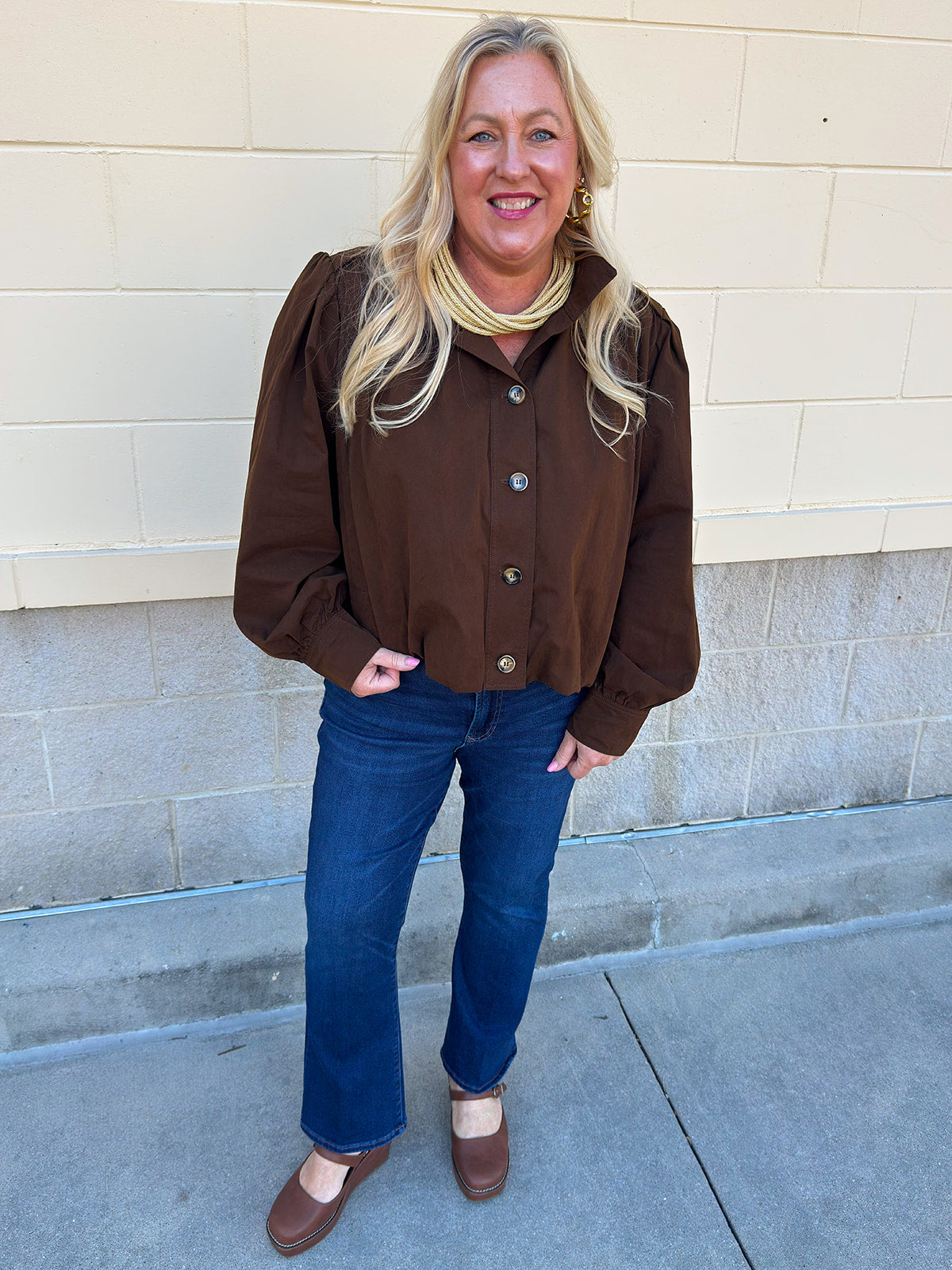 Hazelnut brown jacket with five front buttons, shoulder button accents, and a versatile high neckline