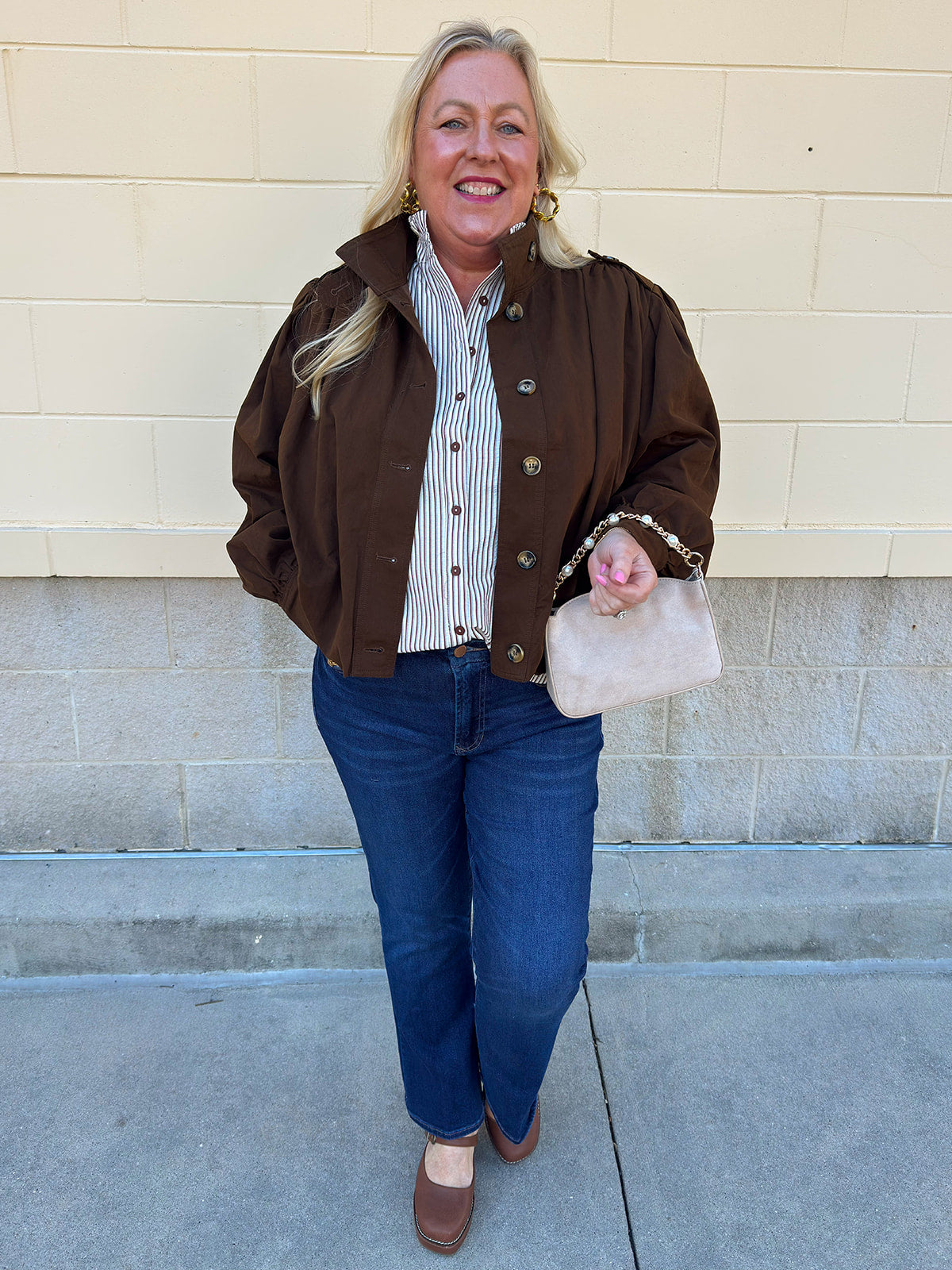 Hazelnut brown jacket with five front buttons, shoulder button accents, and a versatile high neckline