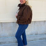 Hazelnut brown jacket with five front buttons, shoulder button accents, and a versatile high neckline