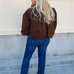 Hazelnut brown jacket with five front buttons, shoulder button accents, and a versatile high neckline