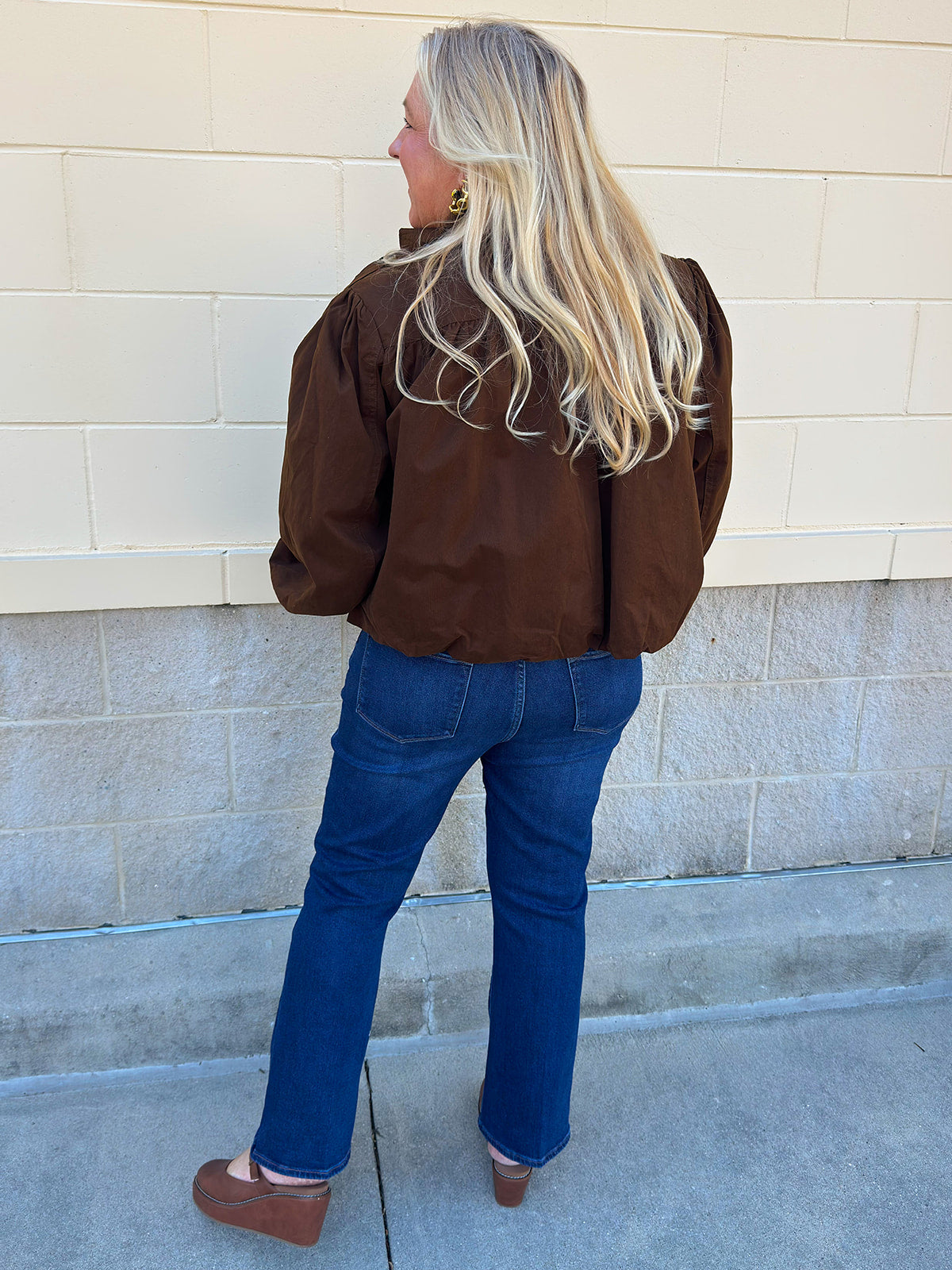 Hazelnut brown jacket with five front buttons, shoulder button accents, and a versatile high neckline