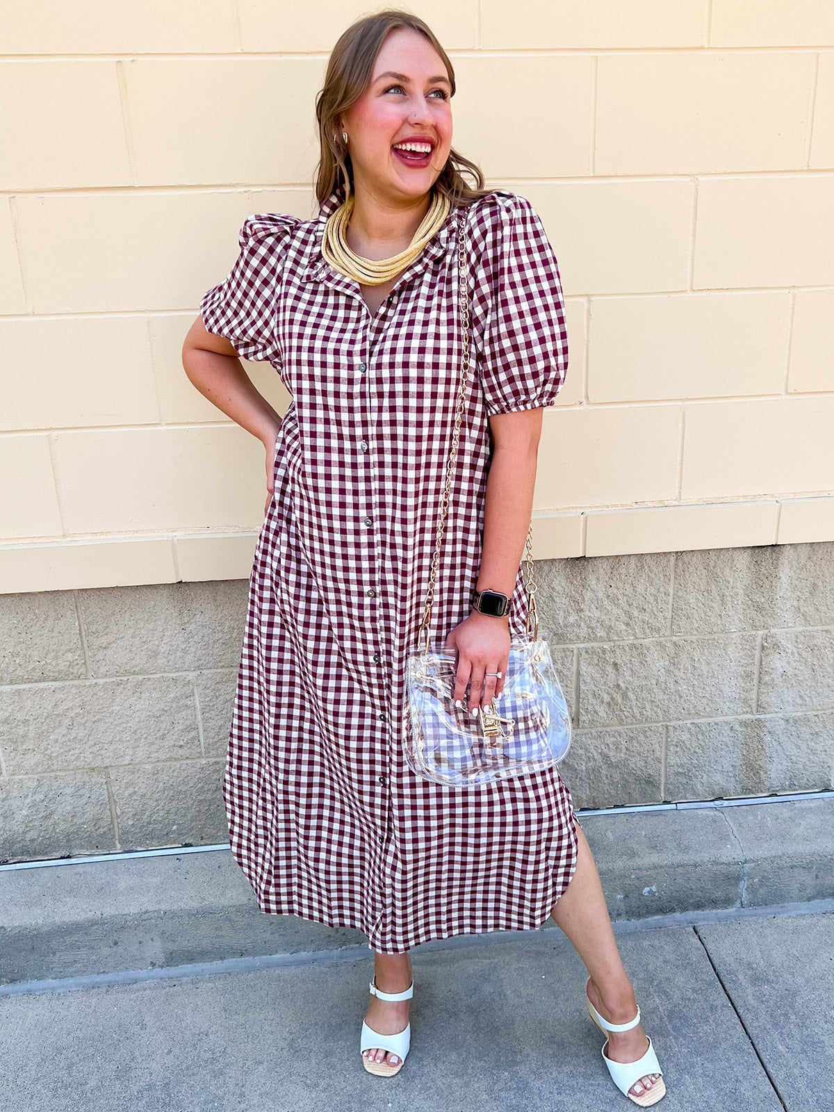 Dark red checkered midi dress with puff sleeves, a ruffled collar, button-down front, hidden side pockets, and a flowing midi-length silhouette.
