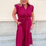 Garnet and red striped sleeveless A-line maxi dress with collared V-neckline, front buttons, and tie waist.