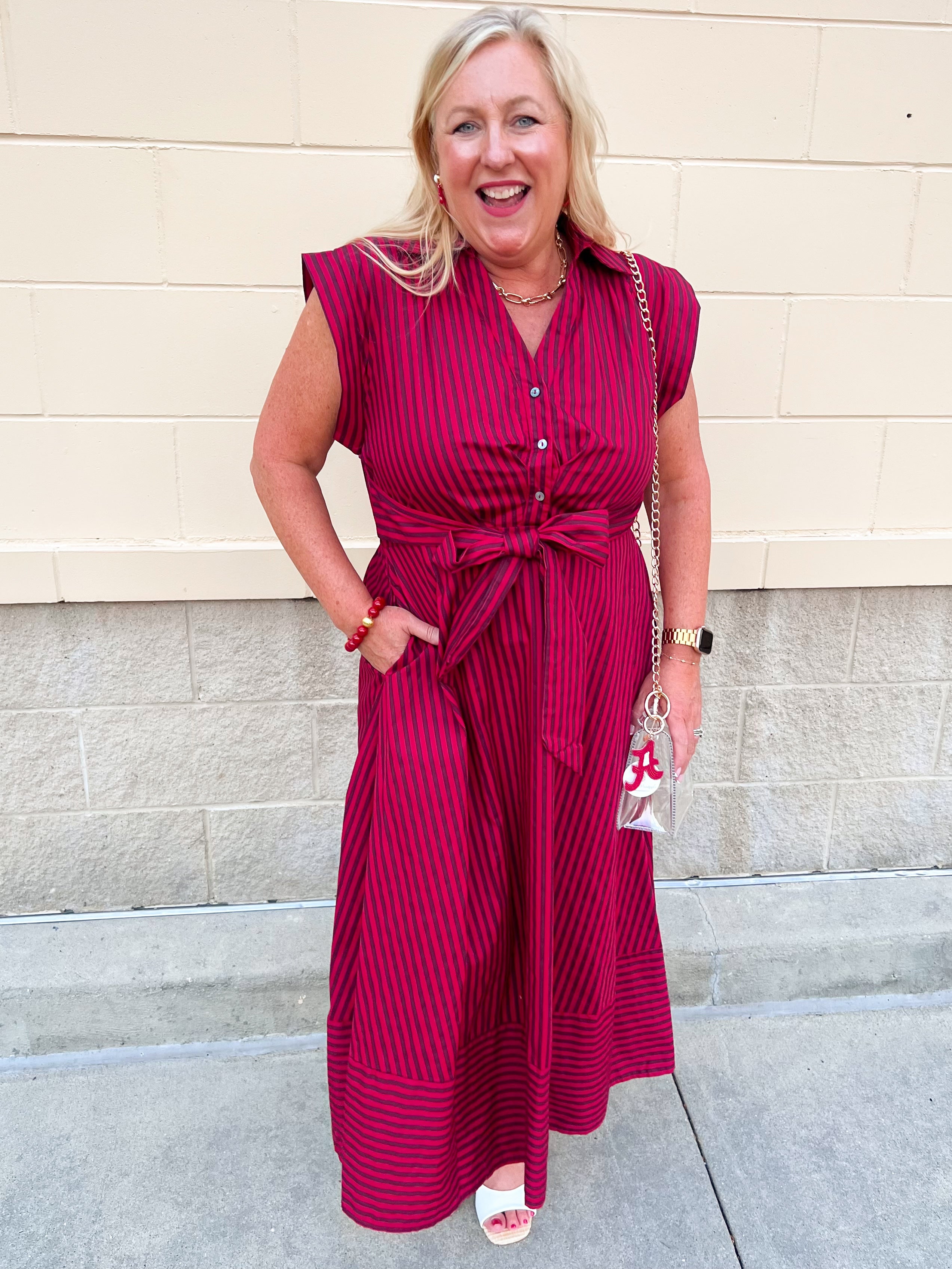 Garnet and red striped sleeveless A-line maxi dress with collared V-neckline, front buttons, and tie waist.