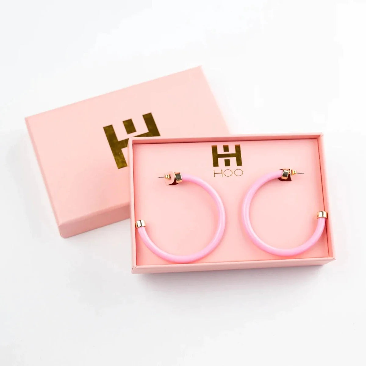 Bright pink 2-inch acrylic hoop earrings—lightweight and bold, perfect for adding a fun pop of color.