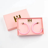 Bright pink 2-inch acrylic hoop earrings—lightweight and bold, perfect for adding a fun pop of color.