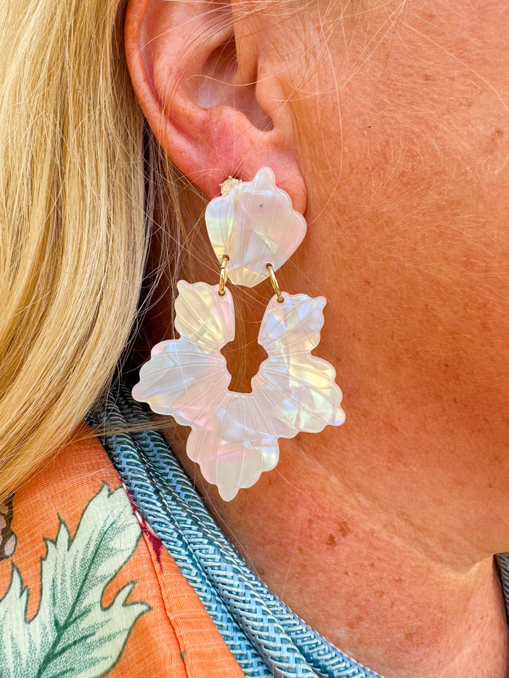 Long iridescent statement earrings with blue, mint, pink, and purple tones, inspired by seashells and crafted from eco-friendly materials