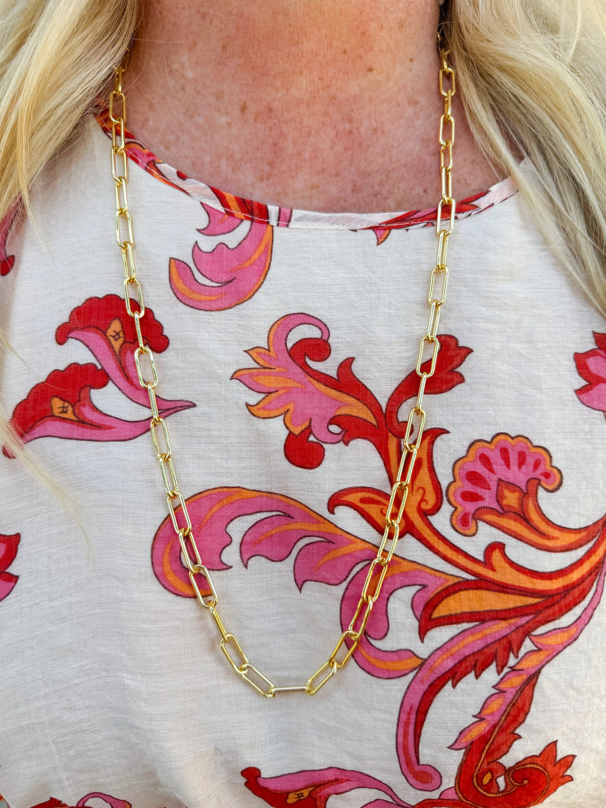 Bright gold long paperclip chain necklace with bold links and a versatile, layerable length