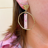 Hammered gold hoop earrings with pink acrylic stick flecked with darker pink, designed by Taylor Shaye.