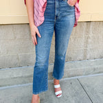 Light wash cropped flare jeans with raw edge hem, styled with a flattering high rise and vintage finish.