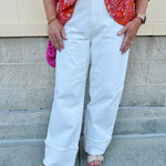 Vanilla-colored cuffed straight-leg jeans made from organic cotton; high-rise fit with luxe, eco-conscious boutique style.