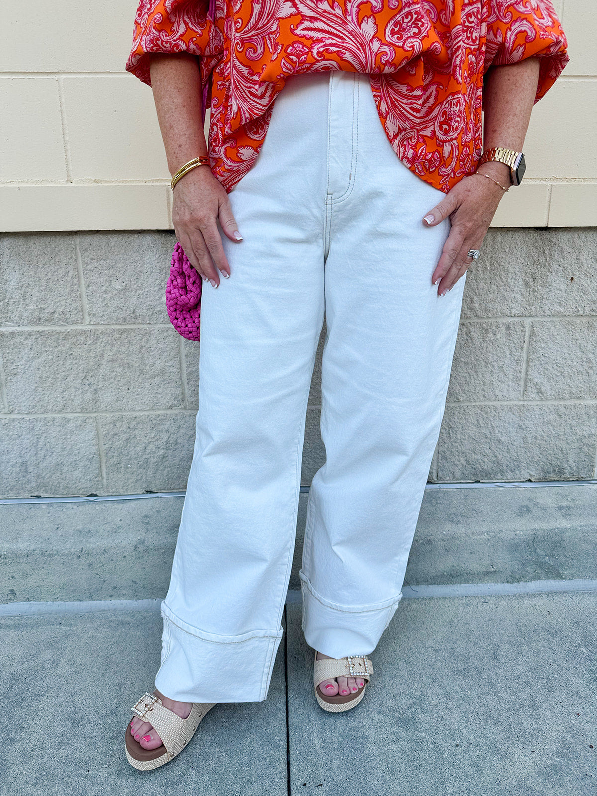 Vanilla-colored cuffed straight-leg jeans made from organic cotton; high-rise fit with luxe, eco-conscious boutique style.