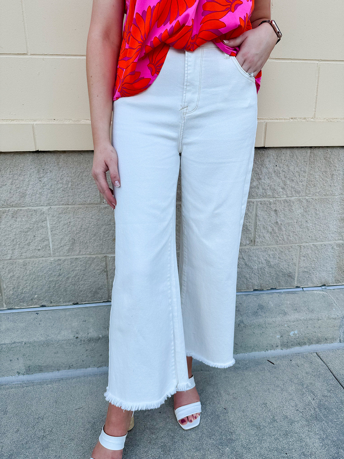 Model wearing the Risen Show Stopper Tummy Control Cream Jeans featuring a high-rise fit, frayed hem, and wide-leg silhouette – styled with a tucked-in top for a flattering, fashion-forward look.