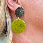 Statement earrings featuring a pistachio green base with gold accents, displayed on a neutral background for a pop of color