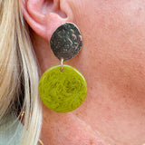 Statement earrings featuring a pistachio green base with gold accents, displayed on a neutral background for a pop of color