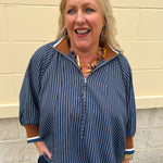 A navy and light blue striped top with camel color block collar and cuffs, styled for fall layering.