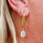Bright gold-tone rectangle hoop earrings with dangling emerald-cut Aurora Borealis crystals from Sorrelli’s Crystal Aurora Borealis Collection.