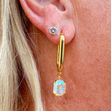 Bright gold-tone rectangle hoop earrings with dangling emerald-cut Aurora Borealis crystals from Sorrelli’s Crystal Aurora Borealis Collection.