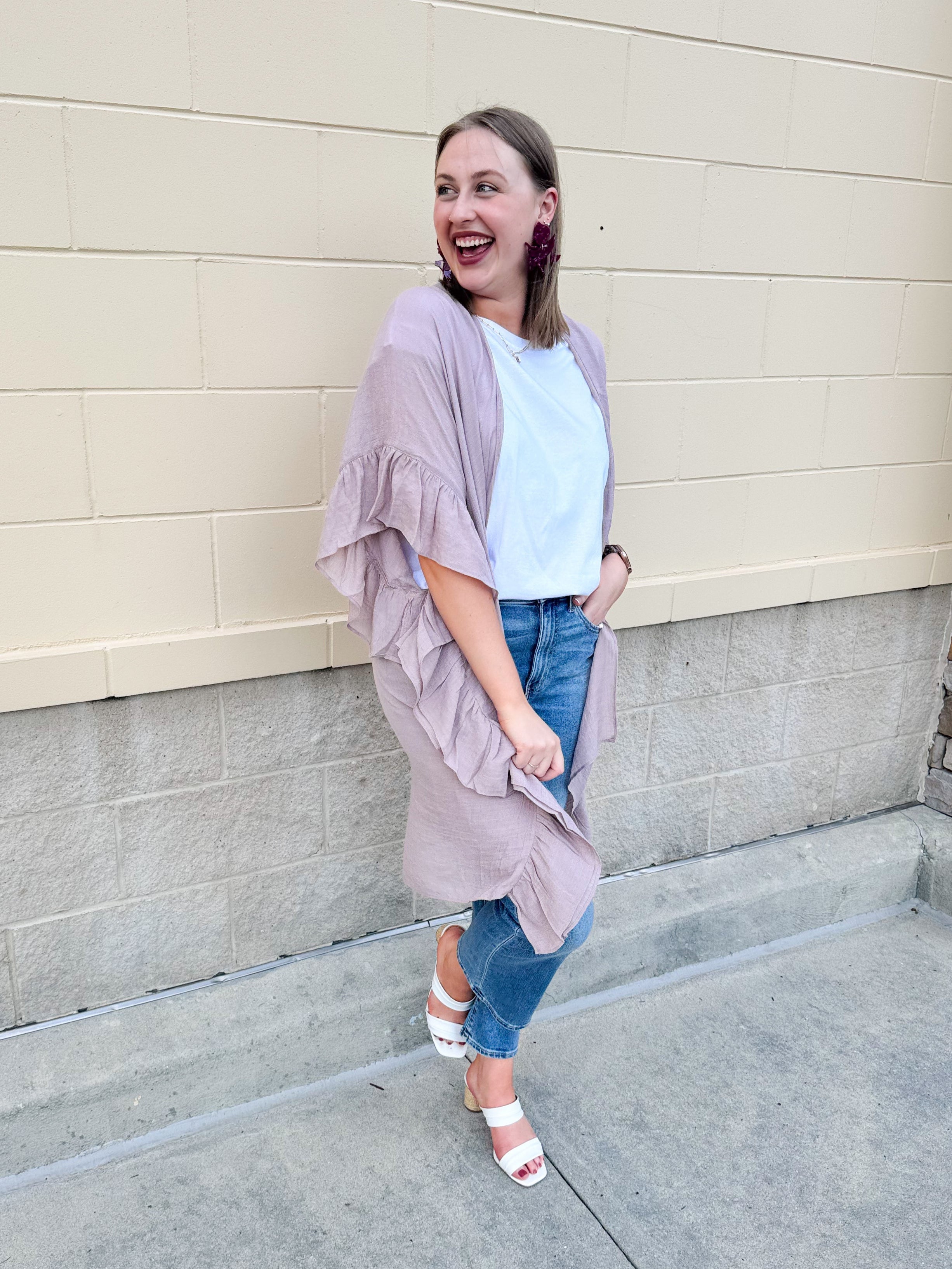 Mauve ruffle duster cardigan with open front and ruffled detailing along sides and sleeves.