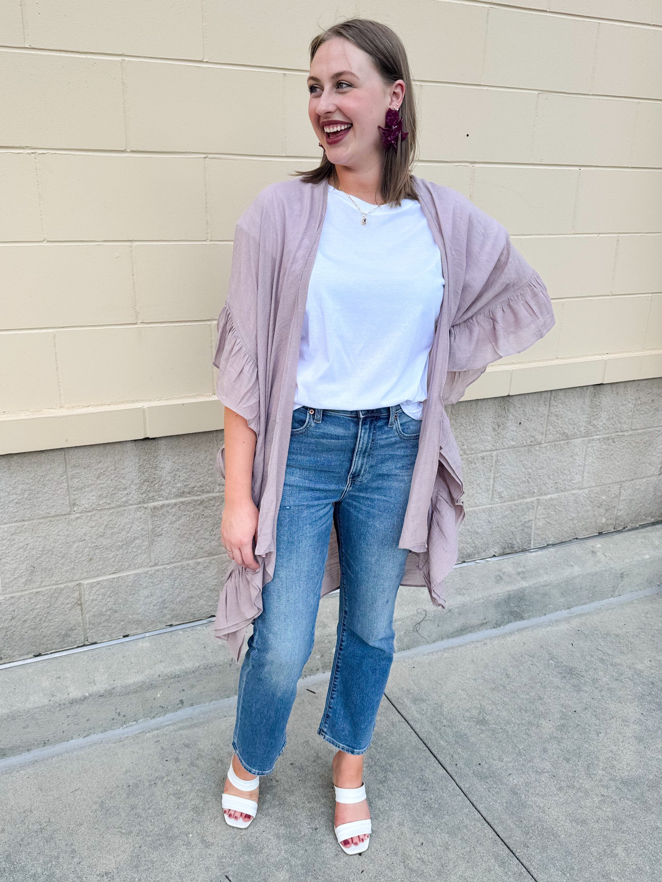 Mauve ruffle duster cardigan with open front and ruffled detailing along sides and sleeves.