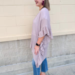Mauve ruffle duster cardigan with open front and ruffled detailing along sides and sleeves.
