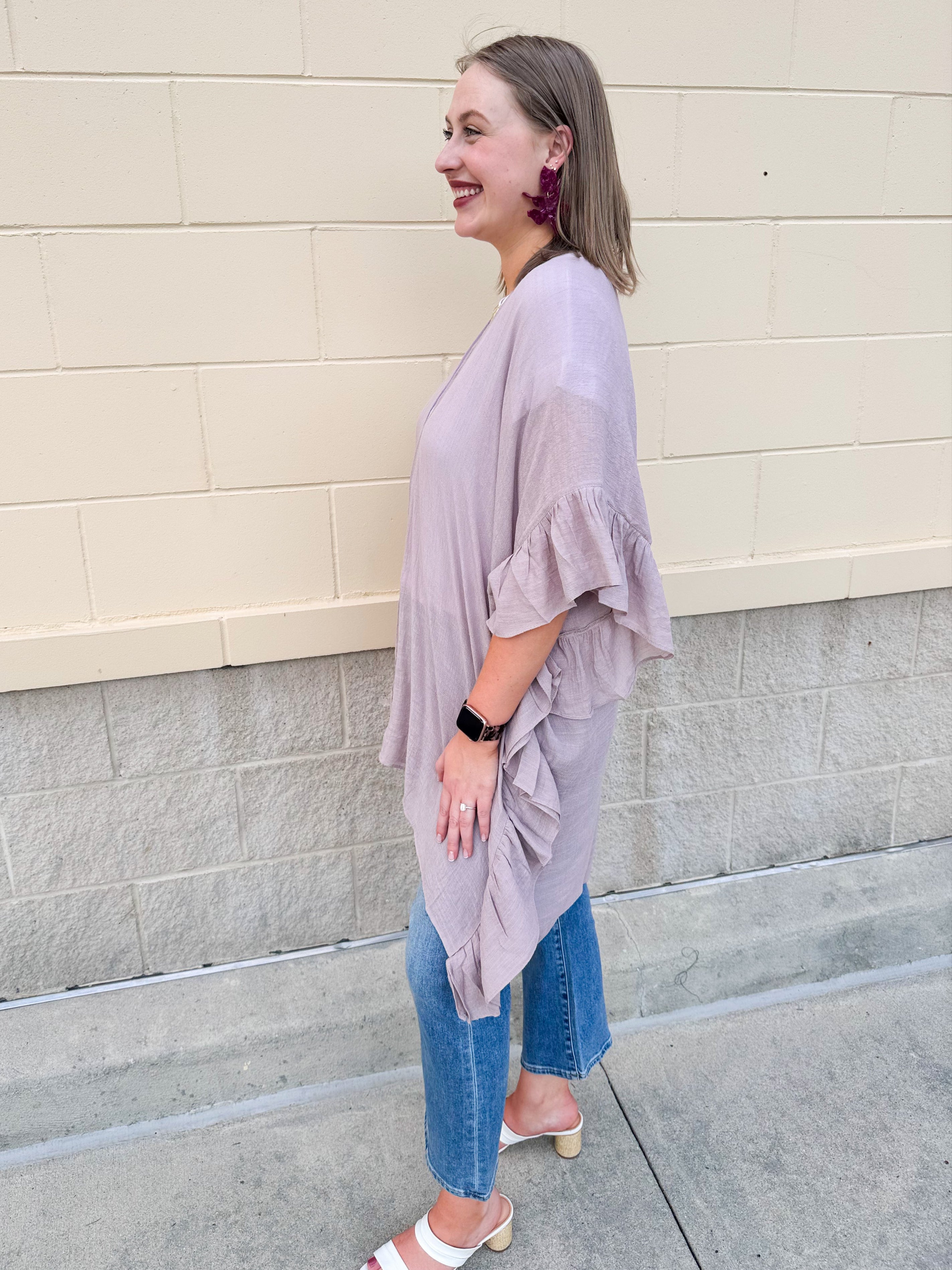 Mauve ruffle duster cardigan with open front and ruffled detailing along sides and sleeves.
