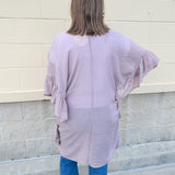 Mauve ruffle duster cardigan with open front and ruffled detailing along sides and sleeves.