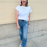 White rolled sleeve tee displayed on hanger or model, showing relaxed fit and classic style.