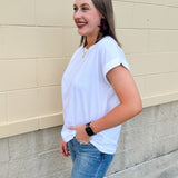 White rolled sleeve tee displayed on hanger or model, showing relaxed fit and classic style.