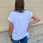 White rolled sleeve tee displayed on hanger or model, showing relaxed fit and classic style.
