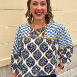 Blue and cream retro geometric print top with velvet trim, ruffle cuffs, and back keyhole.