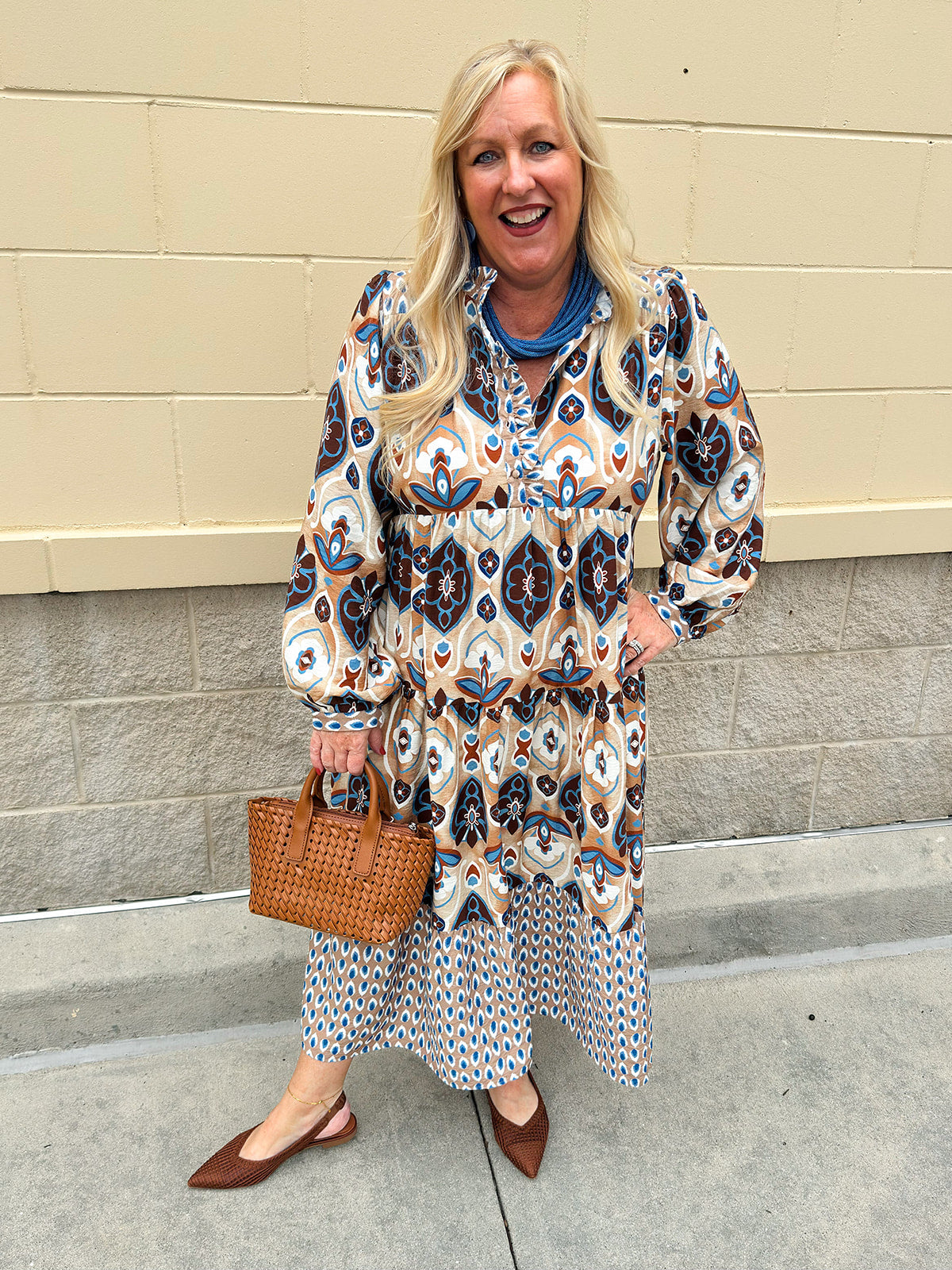 Tiered midi dress in fall blues, creams, and browns with ruffled collar and button-down placket.