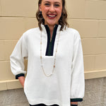 Ecru waffle quarter-zip top with navy and green color block and navy cuffed ¾ sleeves