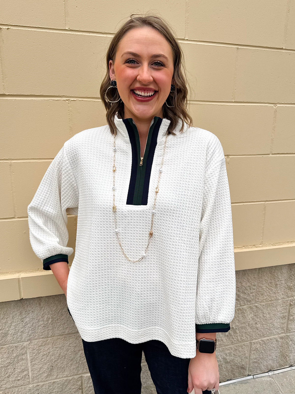 Ecru waffle quarter-zip top with navy and green color block and navy cuffed ¾ sleeves
