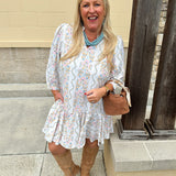 White floral mini dress with ¾ sleeves and colorful pink, orange, green, and blue print