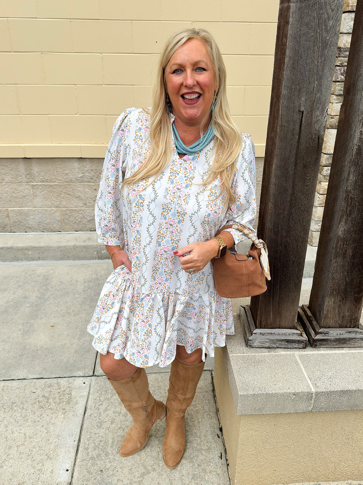 White floral mini dress with ¾ sleeves and colorful pink, orange, green, and blue print