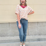 Bright floral v-neck top with dolman sleeves and drop shoulder design, styled for a relaxed and feminine look.