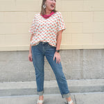 Bright floral v-neck top with dolman sleeves and drop shoulder design, styled for a relaxed and feminine look.