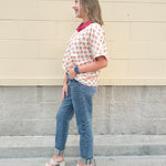 Bright floral v-neck top with dolman sleeves and drop shoulder design, styled for a relaxed and feminine look.